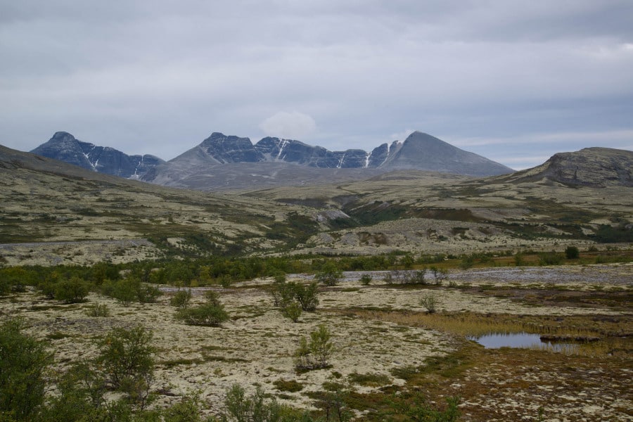 Hügelige Fjell-Landschaft in Norwegen mit Bergen und Wolken.