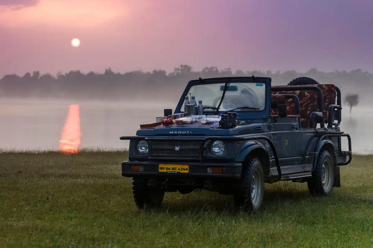 A safari car in Satpura National Park at sunset.
